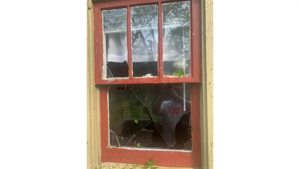 window with broken glass due to storm damage